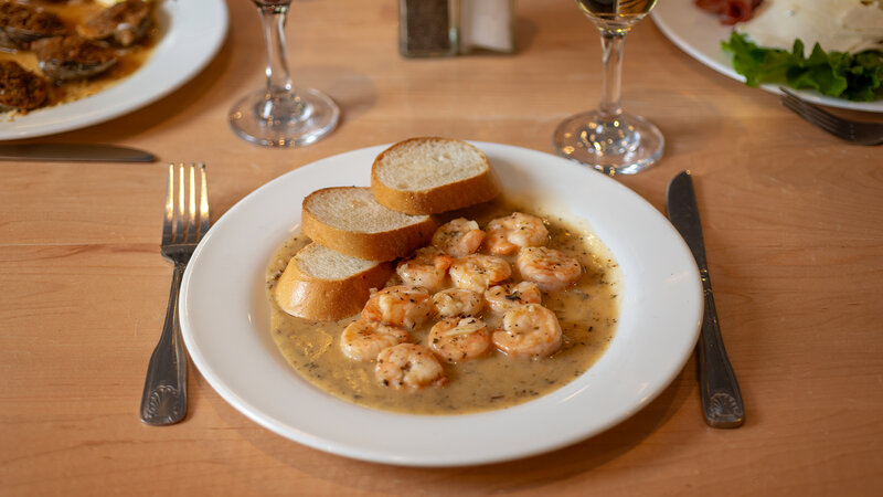 Shrimp in a white sauce with side of bread