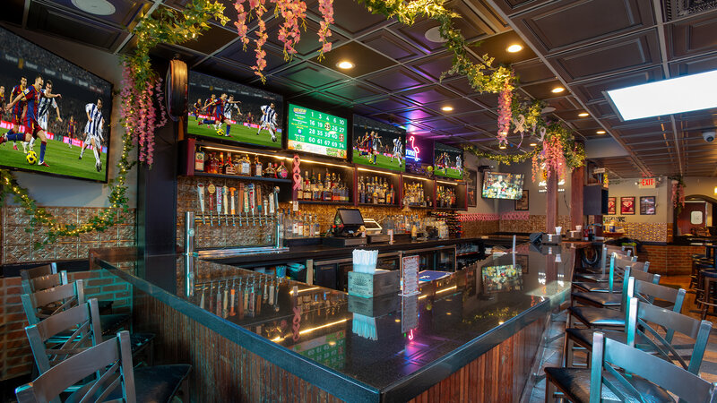 Bar with flowers hanging from ceiling