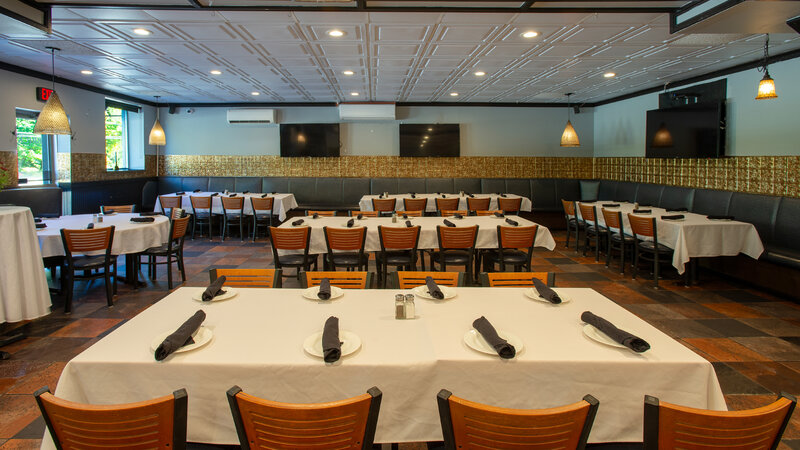 Long tables in private dining room set for eight guests